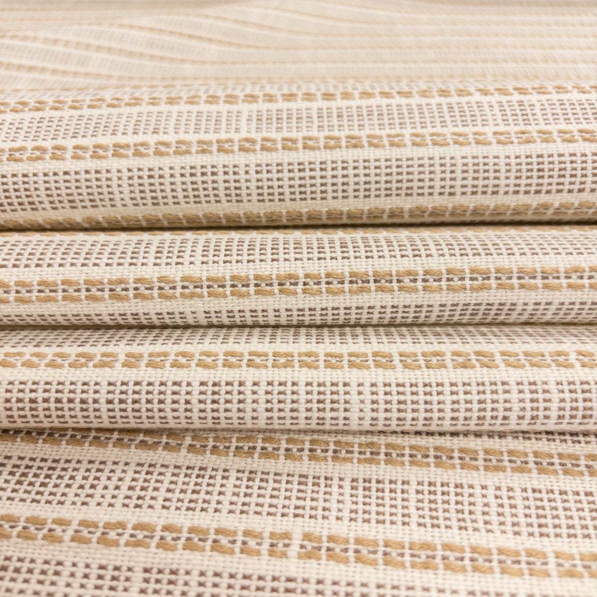 Close-up of Sailor Sisal upholstery fabric in warm neutral tones with a textured woven stripe pattern