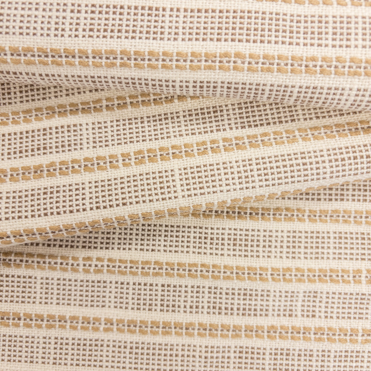 Close-up of Sailor Sisal upholstery fabric in warm neutral tones with a textured woven stripe pattern