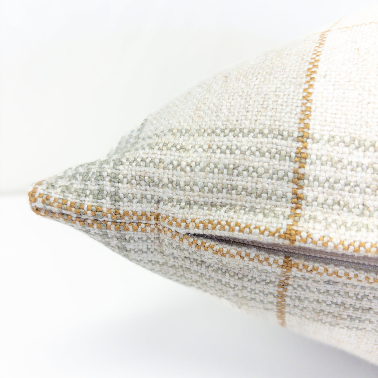 Close-up of a textured pillow with a checkered pattern on a white background