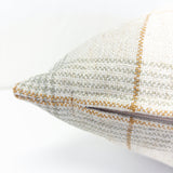 Close-up of a textured pillow with a checkered pattern on a white background