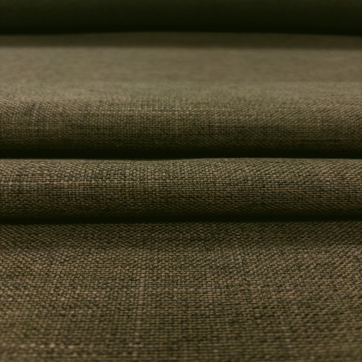 Close-up of olive green fabric with a textured pattern