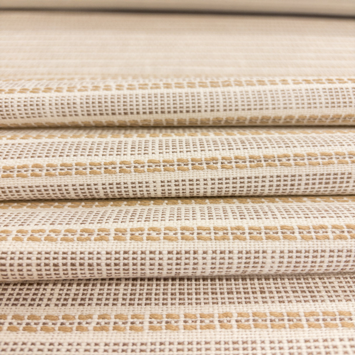Close-up of Sailor Sisal upholstery fabric in warm neutral tones with a textured woven stripe pattern
