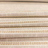 Close-up of Sailor Sisal upholstery fabric in warm neutral tones with a textured woven stripe pattern